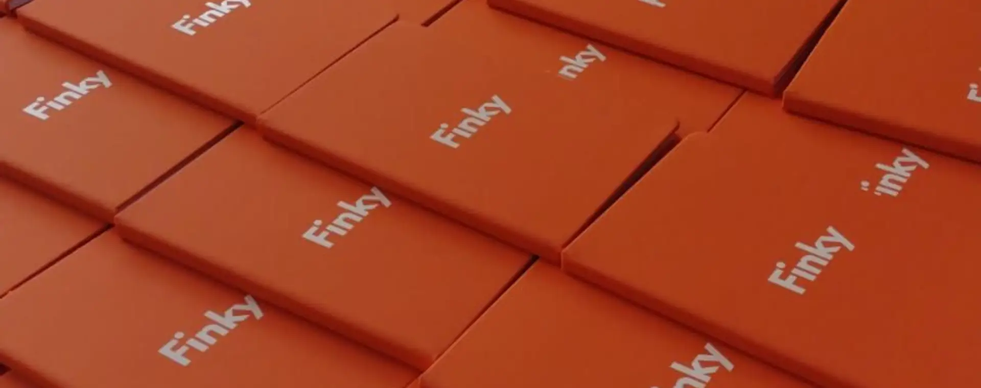 Libretas naranjas personalizadas con logo blanco apiladas en lote