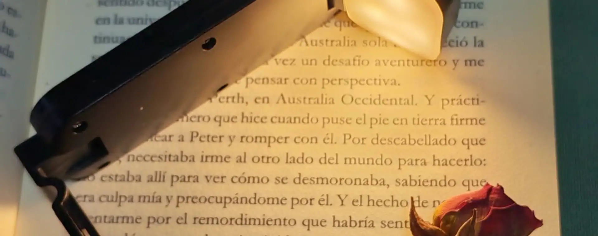 Lámpara de lectura recargable personalizada con logo sobre un libro abierto